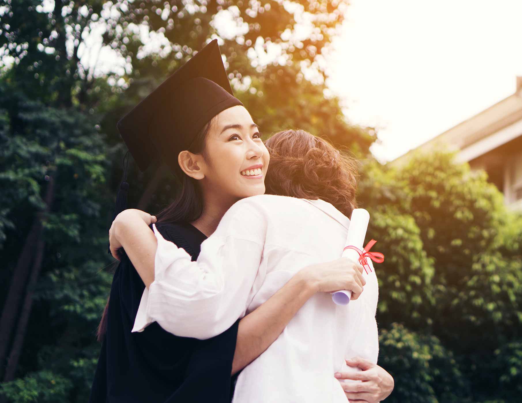 women hugging at graduation