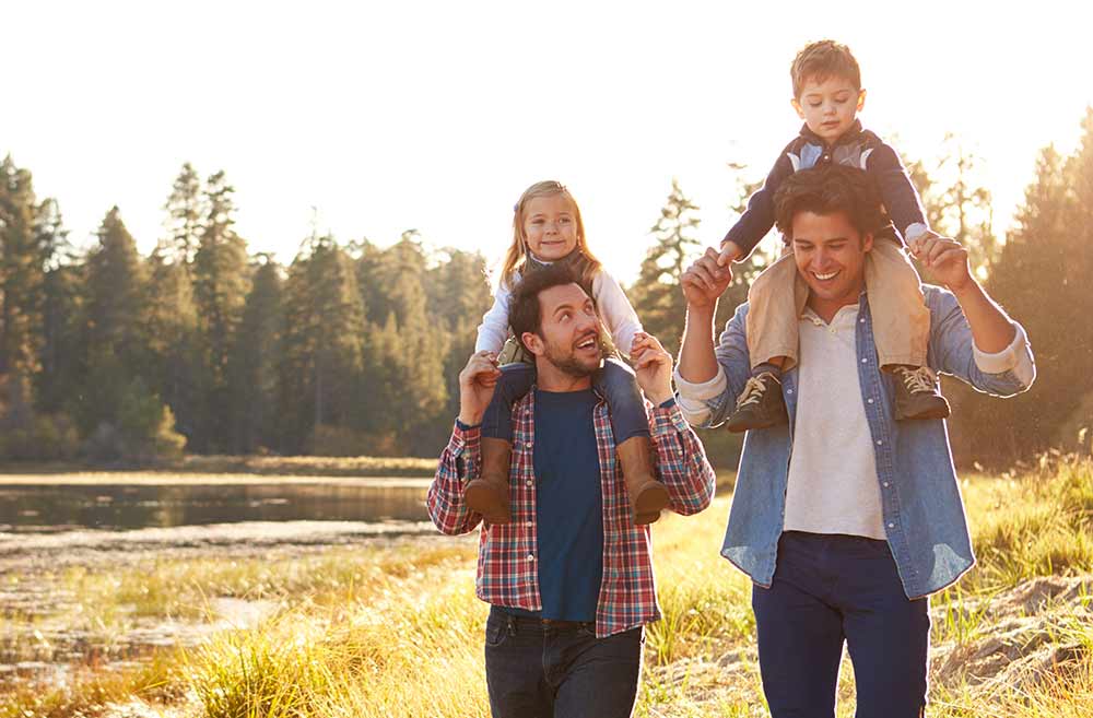 two men hiking with their children