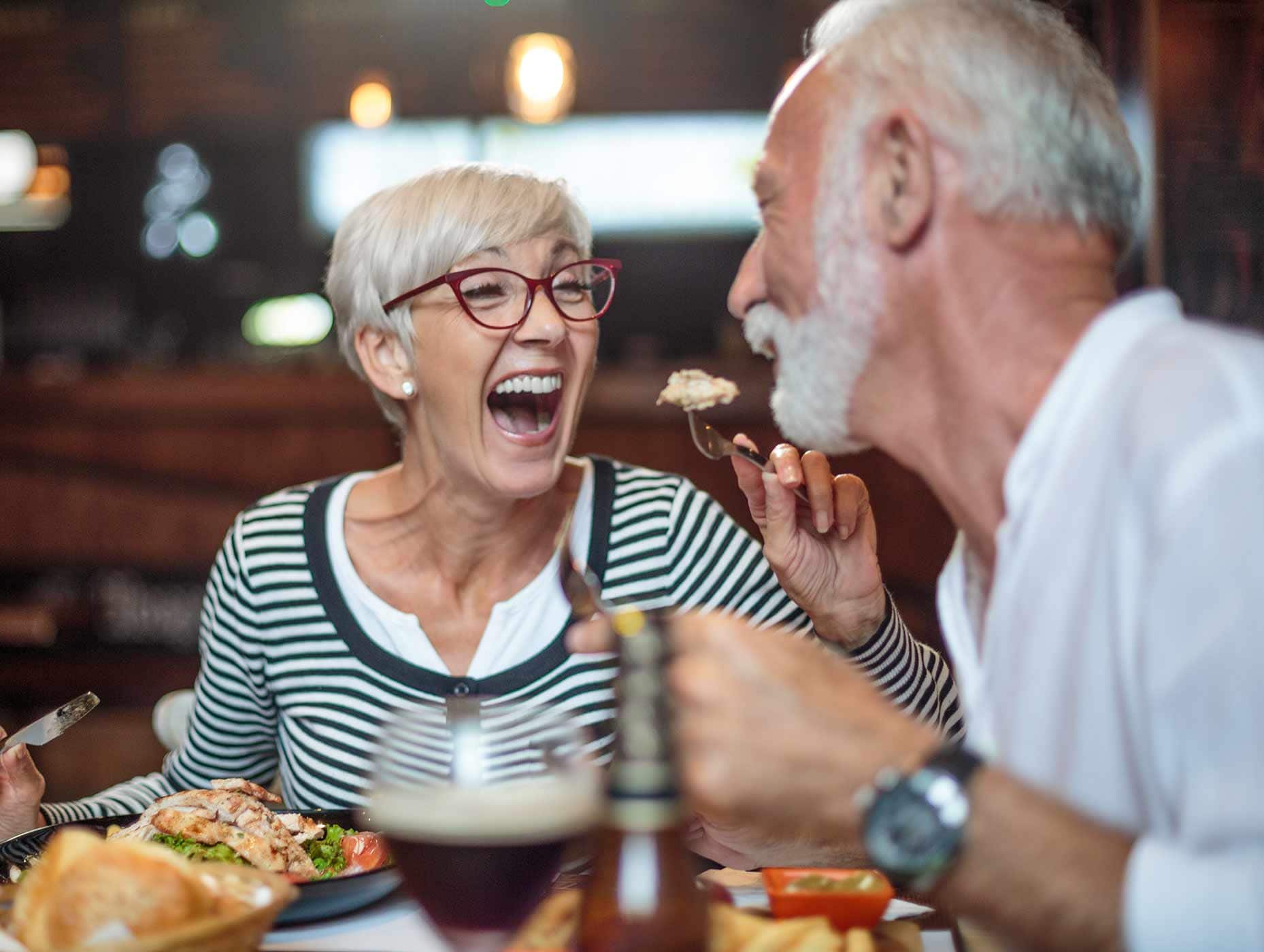 a senior couple sharing dinner